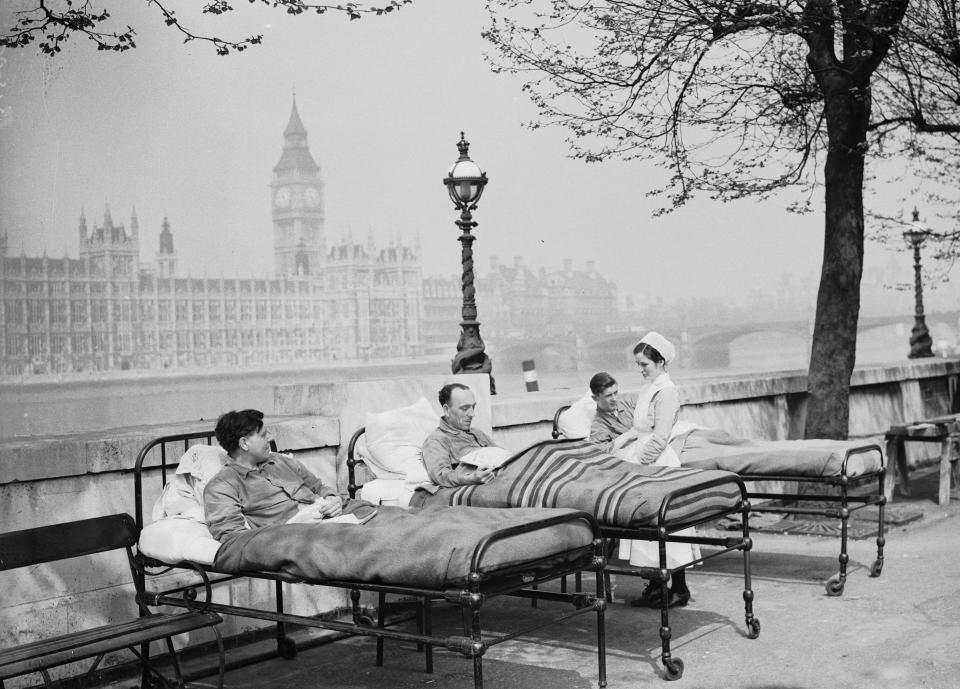  Tuberculosis patients from St. Thomas' Hospital rest in their beds in the open air by the River Thames, opposite the Houses of Parliament in May 1936