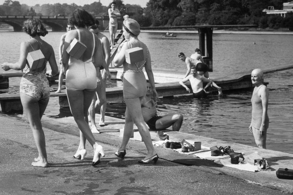  Three women pictured going for a swim in the Serpentine, Hyde Park, London, complete with their gas masks.