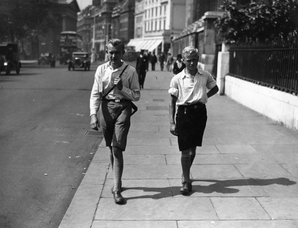  Two young men out for a walk wearing shorts because of a heatwave in 1932