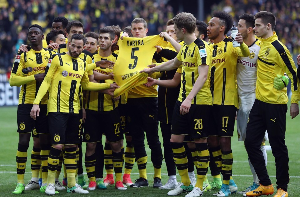 The Borussia Dortmund squad pay their respects to Marc Bartra after he was injured in the bus attack midweek