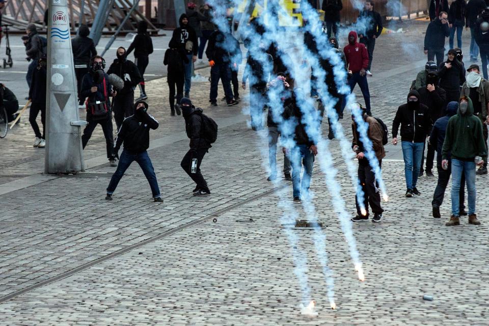  Tear gas canisters land next to troublemakers throwing rocks at cops