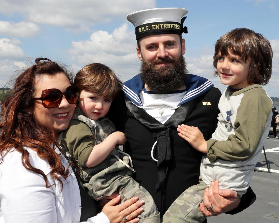  A family celebrate at the waterfront in Plymouth after the ship landed today