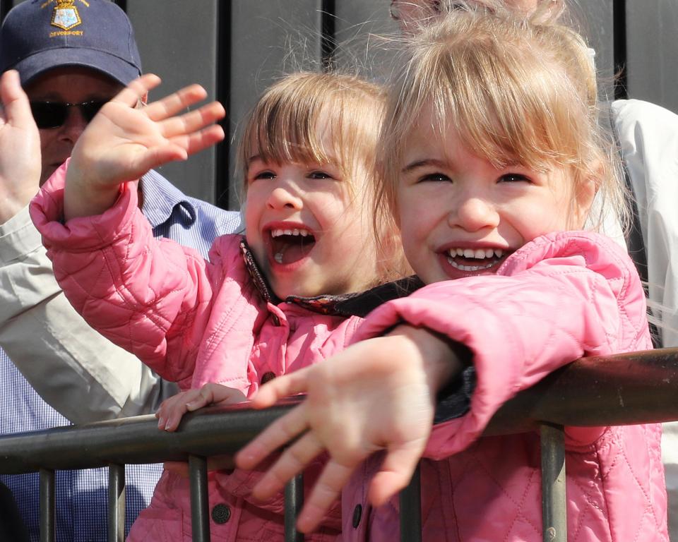  Summer and Amelia, three, wave to the ship as they wait to greet their dad, who shipped off just after they were born