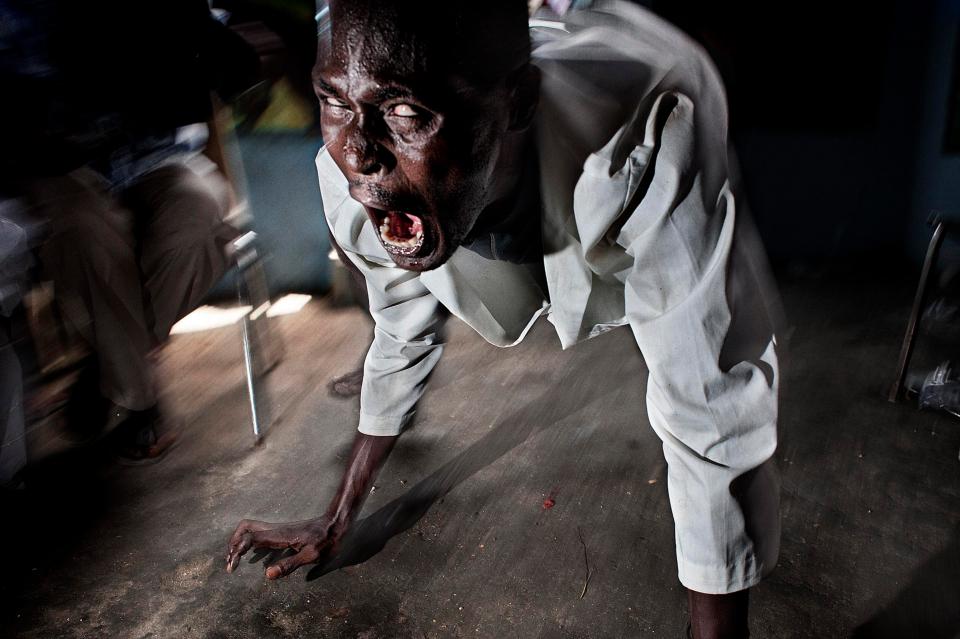  A voodoo priest possessed by an evil spirit during a collective ceremony