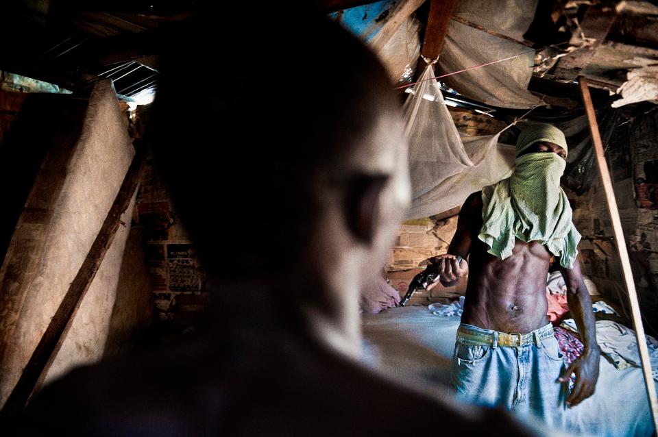  Inside Wilner’s shack. He is 23 years old, He is the leader of his gang called Soleil noir (black sun). Wilner in his shack in Belencourt district.