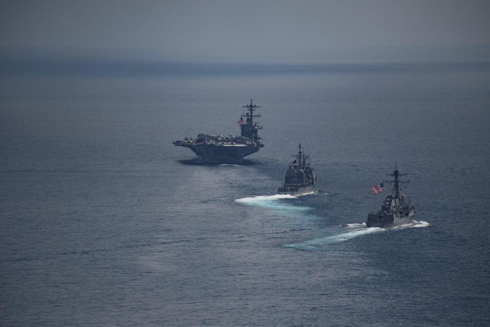  The aircraft carrier USS Carl Vinson leads the Arleigh Burke-class guided-missile destroyer USS Michael Murphy