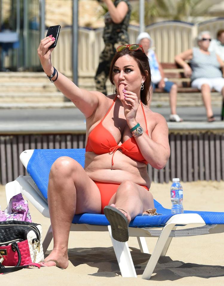  Lisa Appleton was pictured gobbling down a sausage as she posed for a sexy selfie