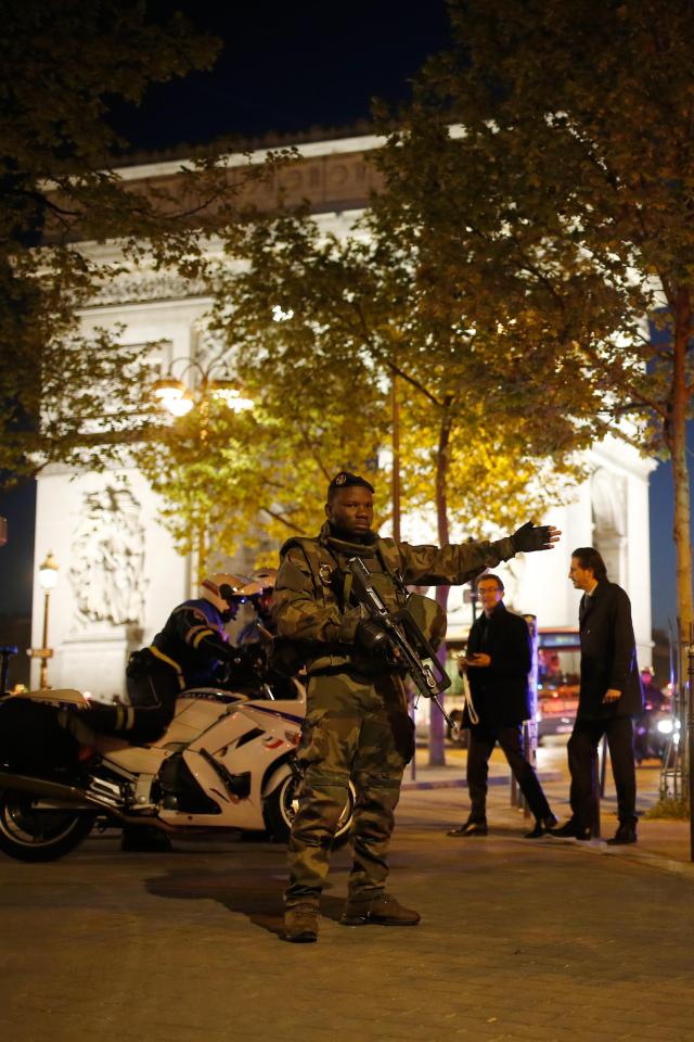  A soldier guides people away from the scene in Paris