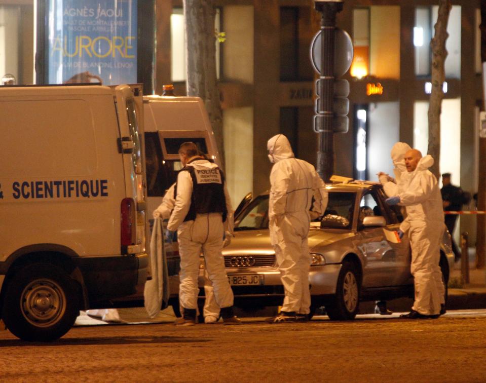  Forensics officers collect evidence from the car used by the Kalashnikov killer