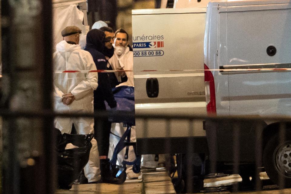  Police remove the body of a policeman who was shot dead as he sat at the wheel of his van