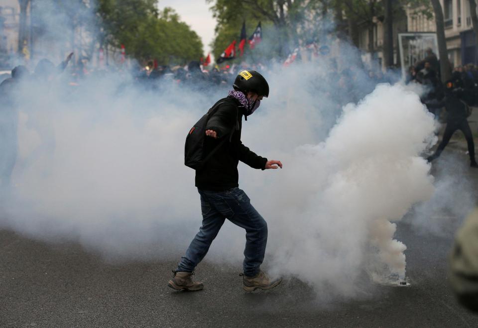  Masked protesters threw flares, stones and bottles at officers in central Paris