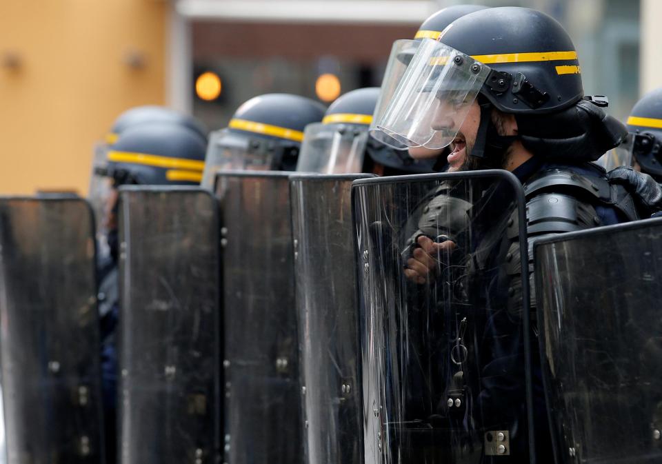  Riot police take position during a protest march on the eve of the first round in the French presidential election