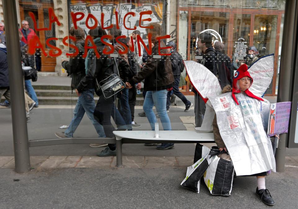  A demonstrator takes a rest at a bus stop during the protest march