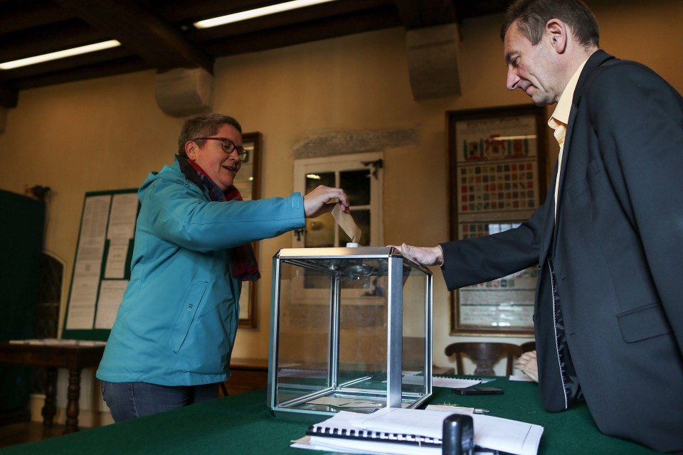 A voter casts her ballot at a polling station in Le Mont-Saint-Michel, northwestern France