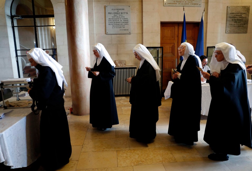 French nuns stationed in an Arab-Israeli village near Jerusalem prepare to cast their vote at the French consulate