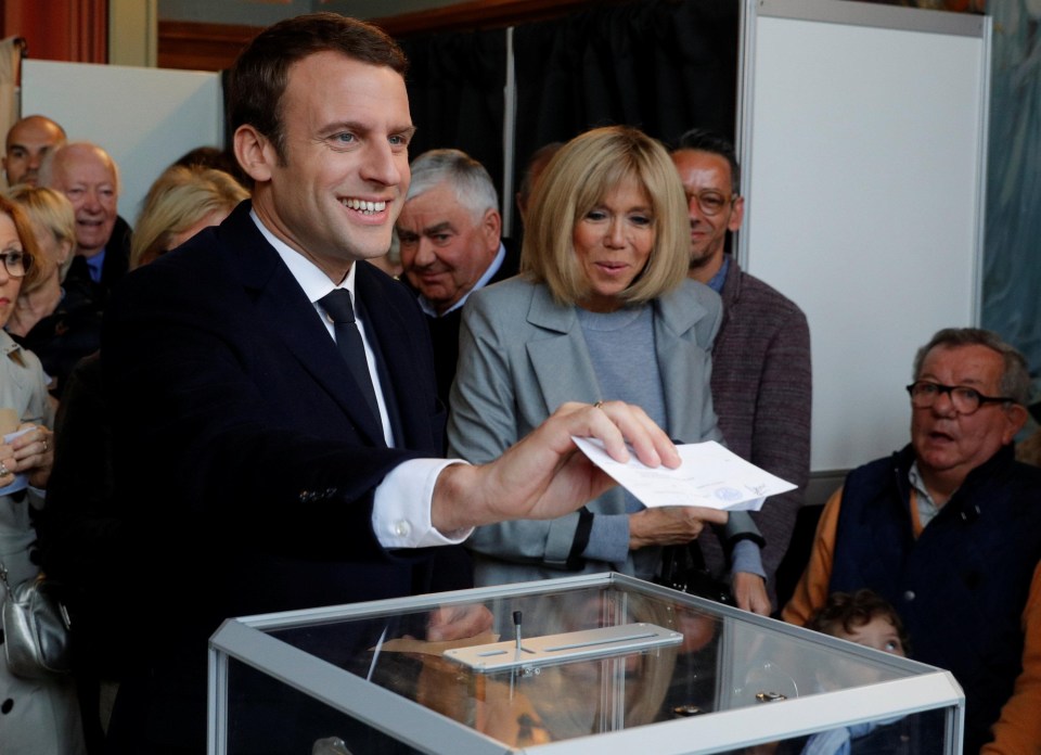 Smiling favourite Emmanuel Macron casts ballot at a polling station in Le Touquet, northern France