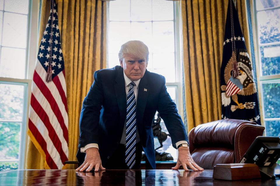  He is pictured at his newly-designed Oval Office, complete with gold curtains - his favourite colour