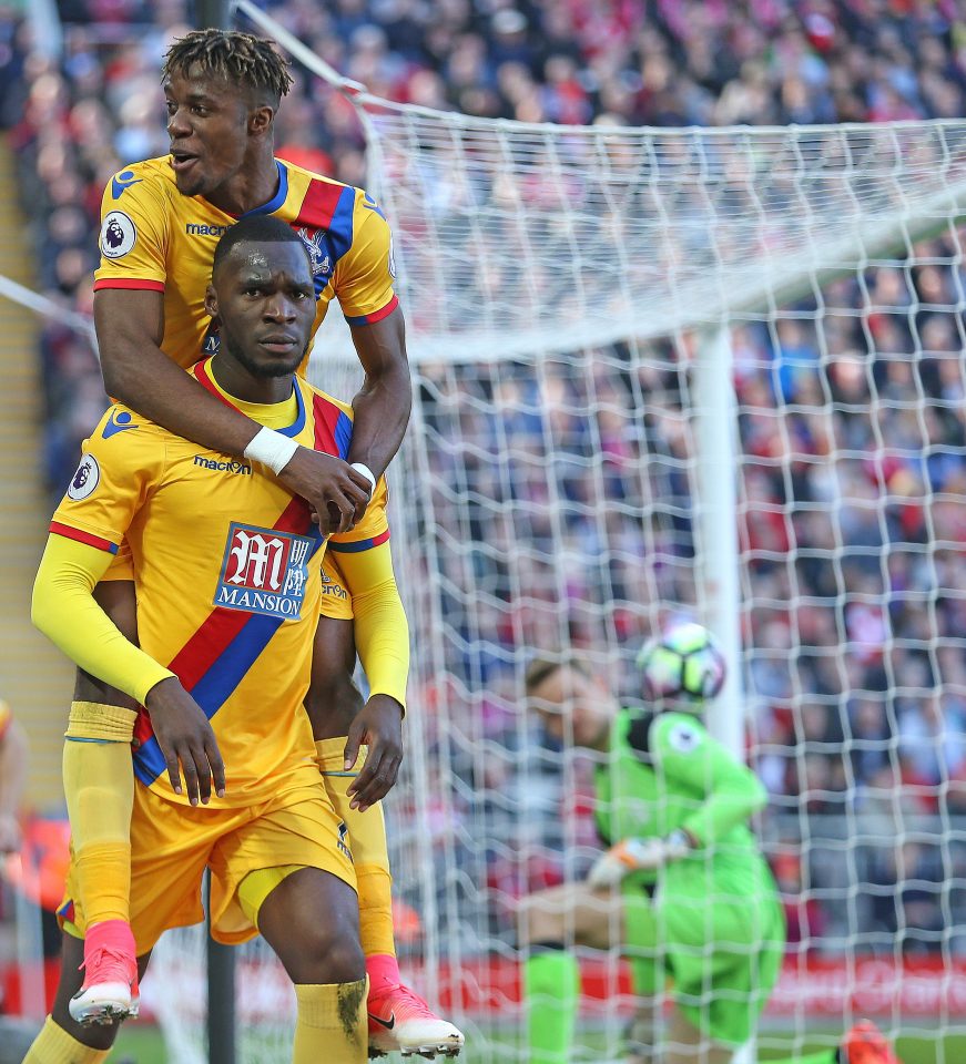  Wilfried Zaha celebrates as former Liverpool striker Christian Benteke hits a stoppage-time winner at Anfield on Sunday