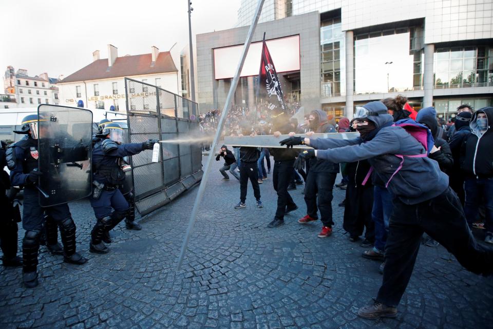  Cops fire tear gas into the crowd of protesters in Paris following the projected results