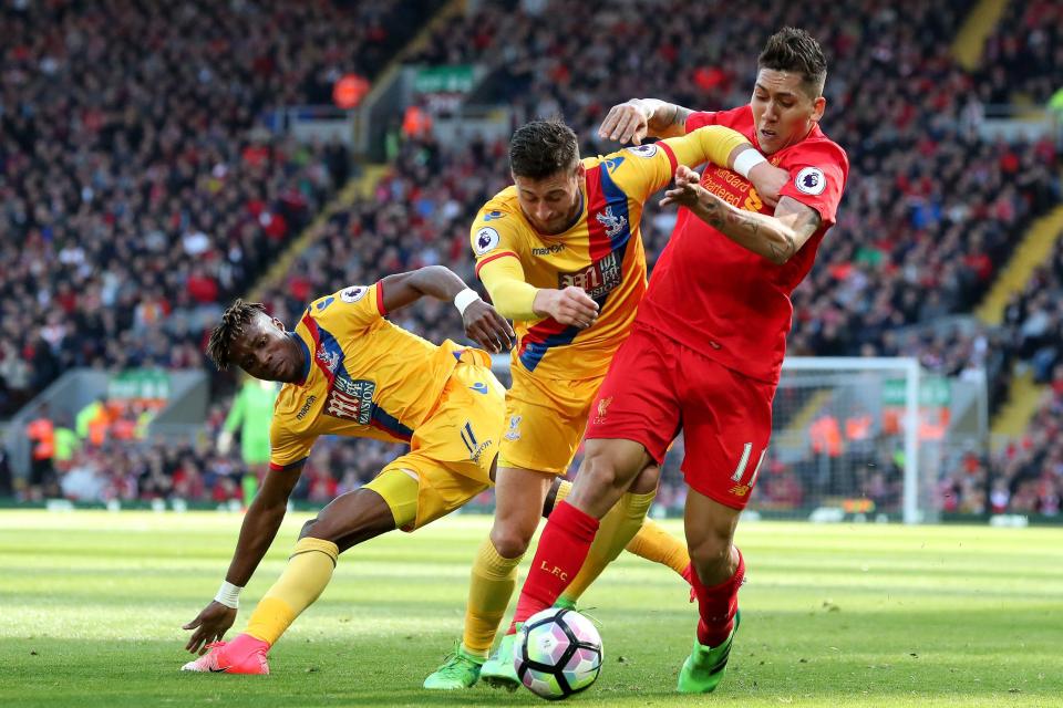  Former Manchester United Wilfried Zaha tangles with Roberto Firmino as Crystal Palace stun Liverpool with a 2-1 win at Anfield