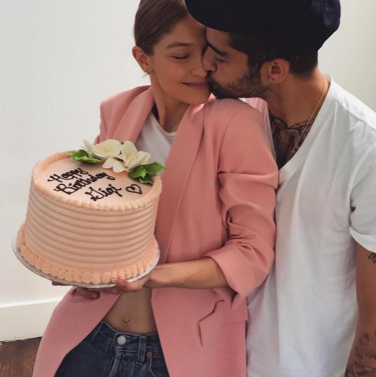  The supermodel posed with a pink birthday cake as he planted a kiss on her cheek