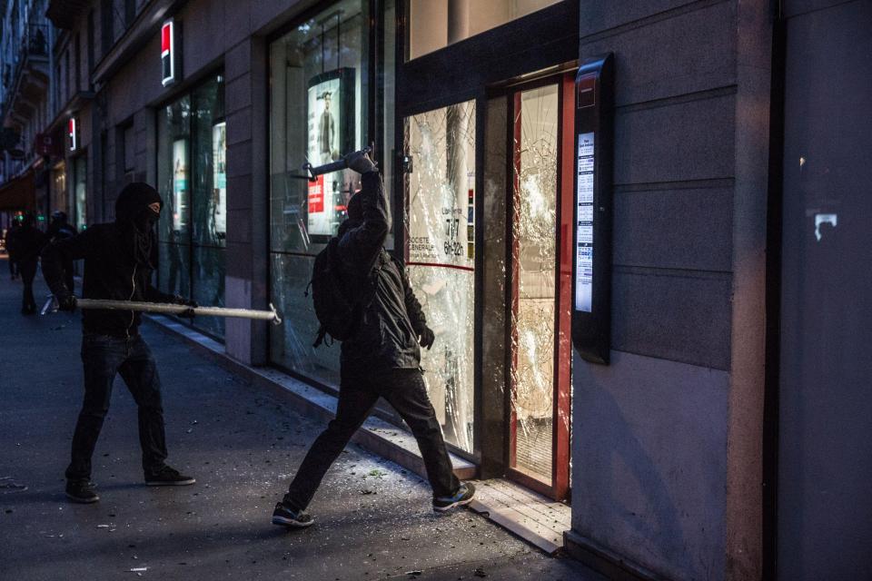  Masked thugs smash the windows of a business in Paris