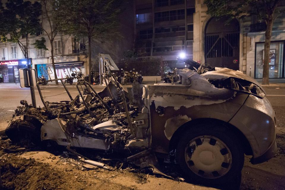  A car is pictured burnt out on the streets of the troubled French capital