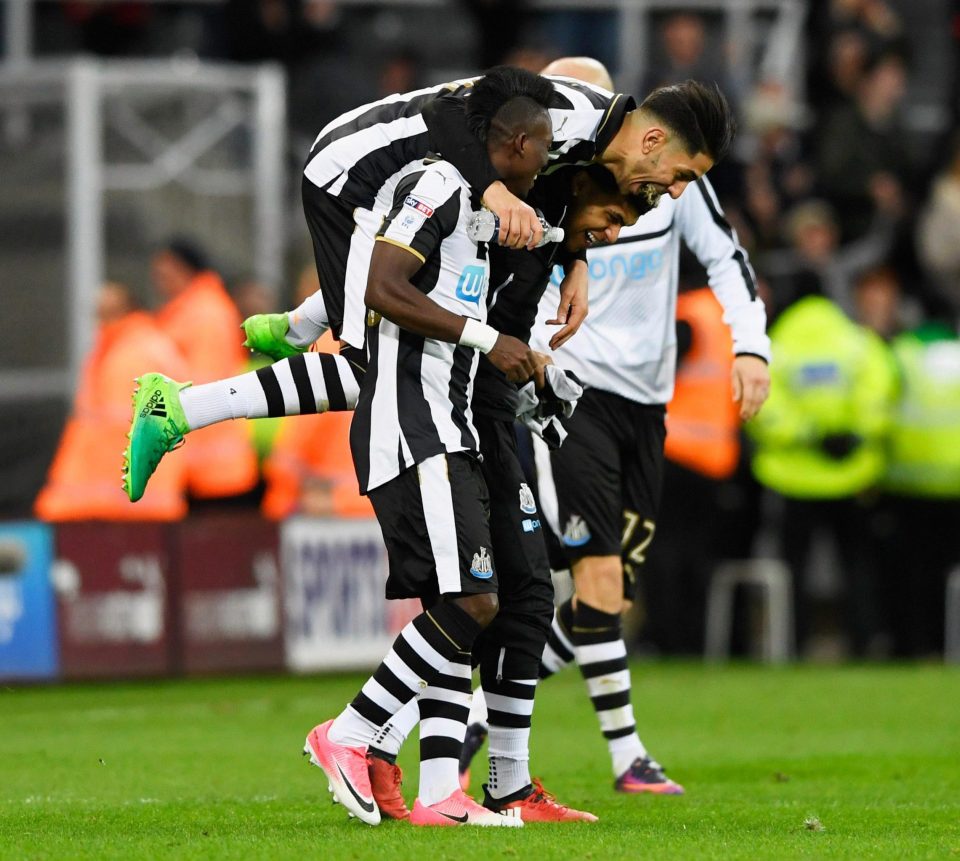  Christian Atsu, Ayoze Perez and DeAndre Yedlin of Newcastle United celebrate victory and promotion