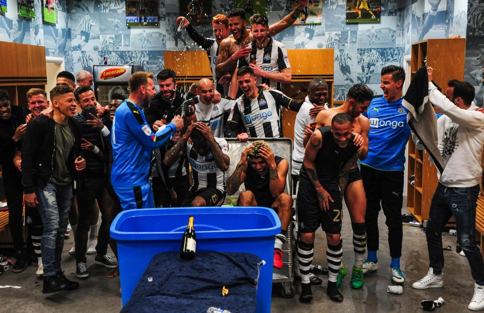  Newcastle players celebrate in their dressing room after gaining promotion