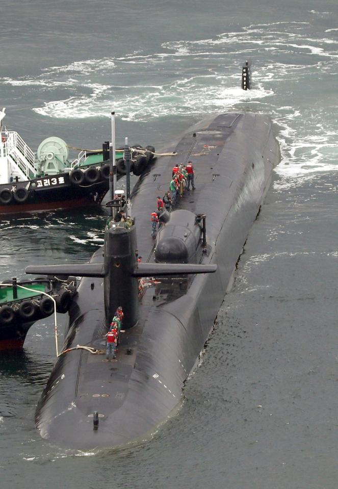  Tugs help push the USS Michigan along a quayside at Busan port as part of Washington's build up of forces ahead of a possible conflict