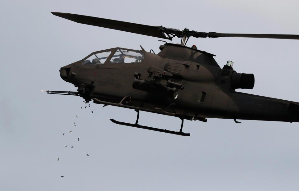  A South Korean AH-1S Cobra Helicopter fires its cannon guns at the imaginary target