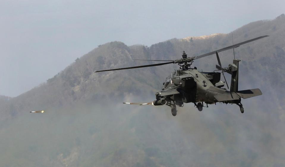  U.S. Army's Apache helicopter fires rockets at ground targets as forces move behind