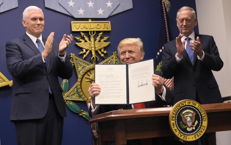 Trump shows off his executive order for a 'great rebuilding' of the creaking US armed services, promising new aircraft, naval ships and more resources for the military