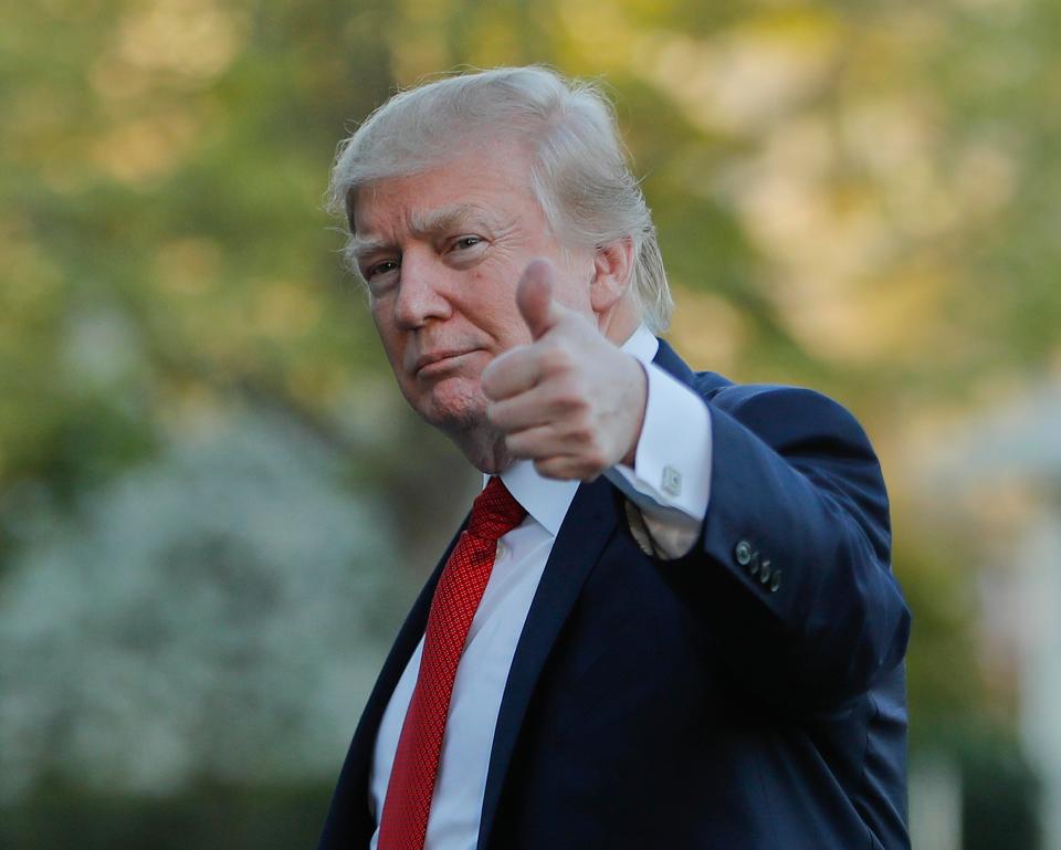 US President Donald Trump gives a thumbs-up after arriving yesterday on Marine One on the South Lawn of the White House in Washington