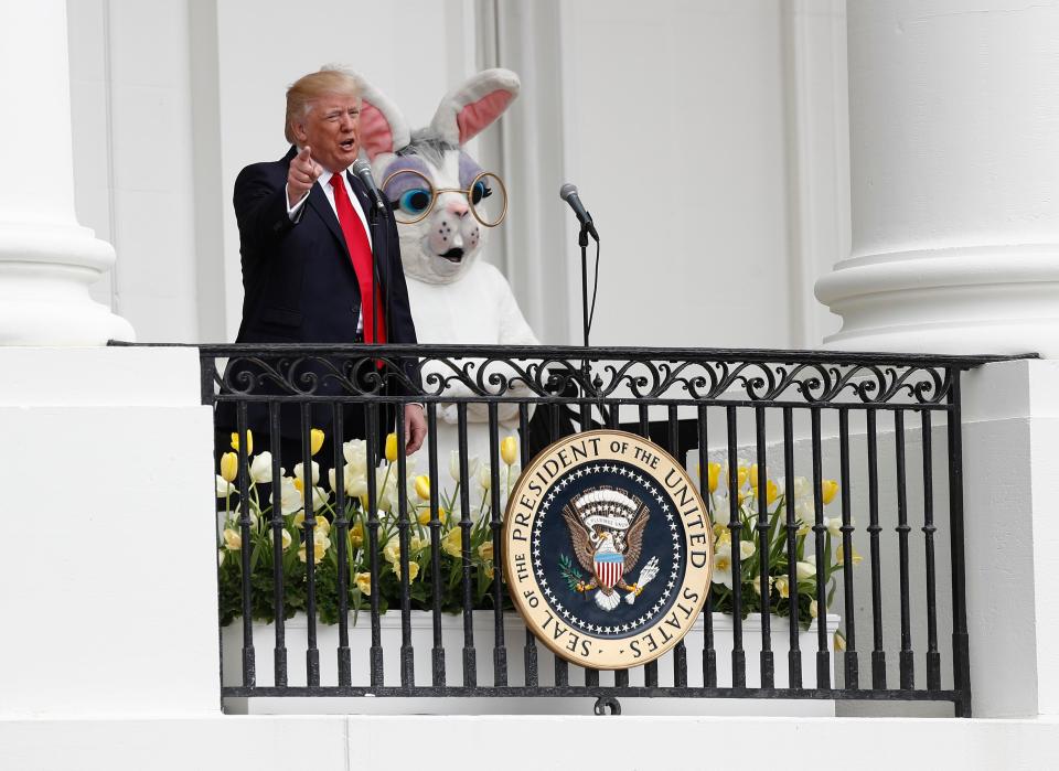 Trump stands with a performer in an Easter Bunny costume at the White House Easter Egg Roll 