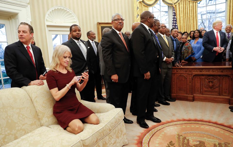 One of Trump's controversial advisers Kellyanne Conway sparked outrage after she was seen sitting on her shoes during a photocall with the President