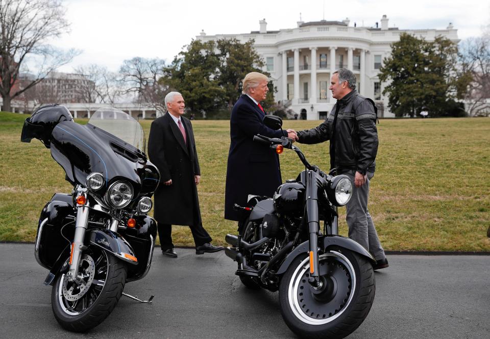 President Donald Trump shakes hands with Matthew S Levatich, CEO of Harley Davidson after vowing to revive US manufacturing 