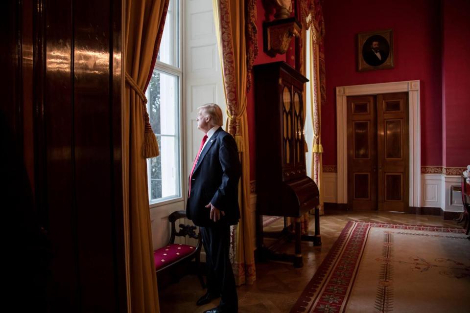  President-elect Donald Trump looks out of the Red Room window onto the South Portico of the White House grounds on Inauguration Day, Friday, January 20, 2017 - exactly 100 days ago today