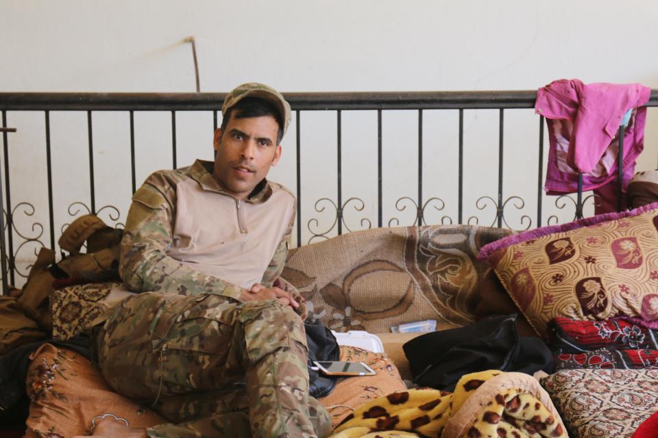  A sniper from the unit, based in an abandoned house, rests during the day