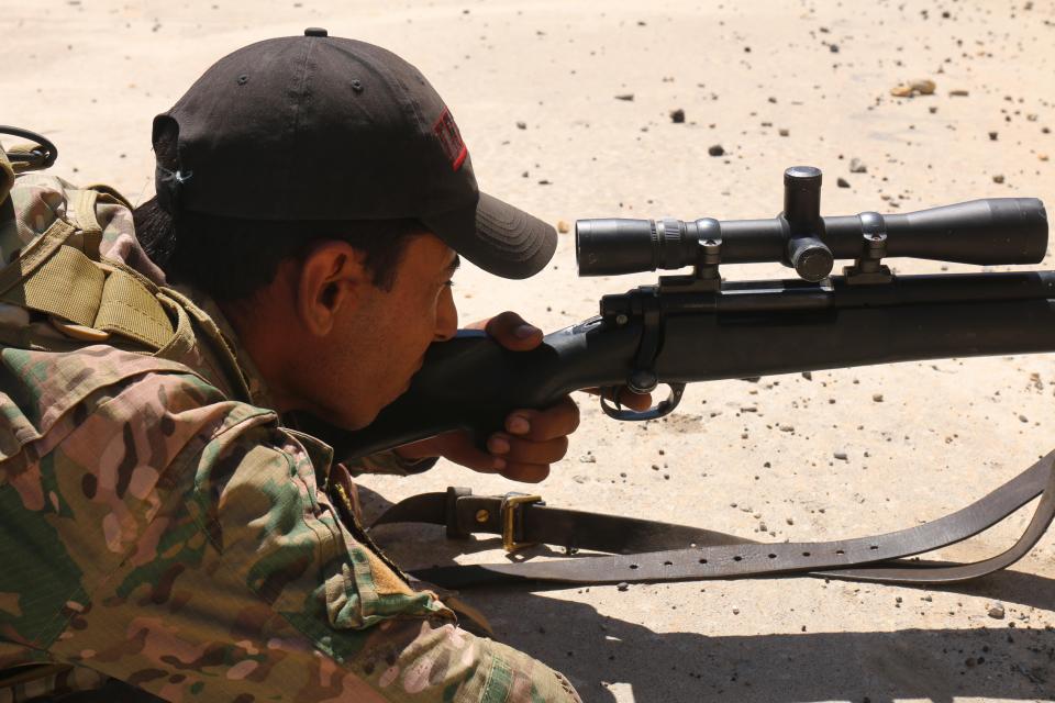  A sniper from the Iraqi Emergency Response Division sniper unit takes aim