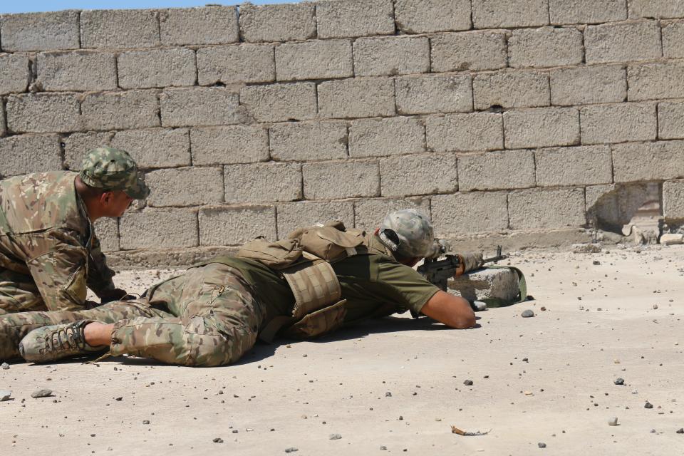  Commander Haydar, left, directs one of his ERD snipers on a Mosul rooftop