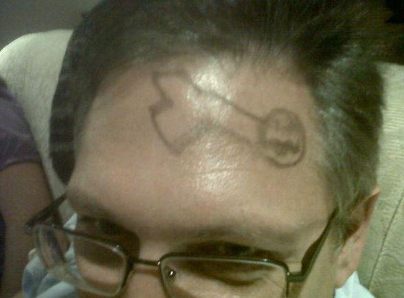 A little girl attempted to draw a picture of a ‘shark’ on her dad’s head… but the adults in the room all thought it looked like something else