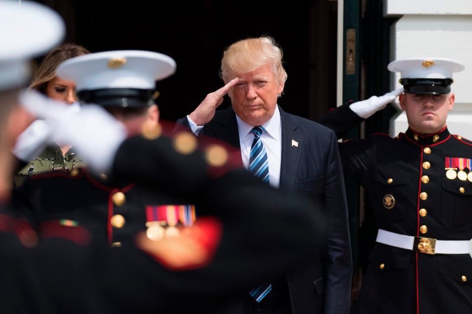  Trump salutes as he walks out to greet visiting Argentinian President Mauricio Macri and his wife Juliana Awada