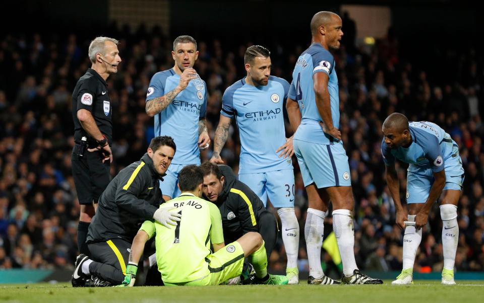  After kicking the ball upfield the stopper immediately fell to the ground in pain as medics made their way on to stretcher him off