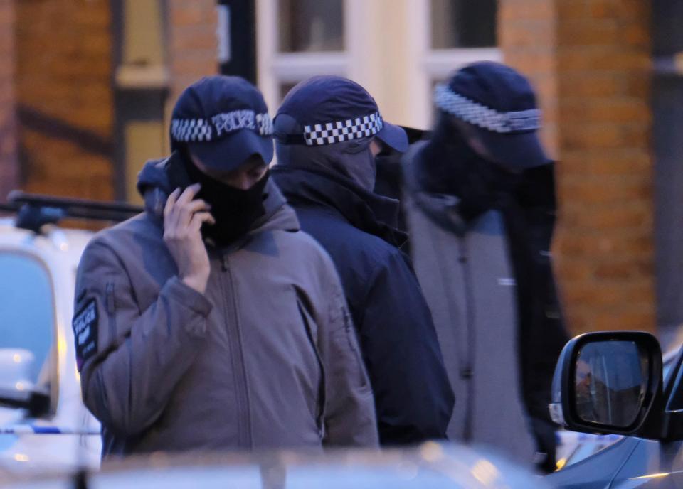  Armed police in masks at the scene of the raid in North West London