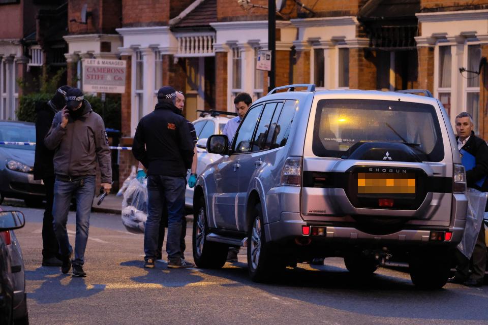  Police officers remained on Harlesden Road after a woman was shot in the raid