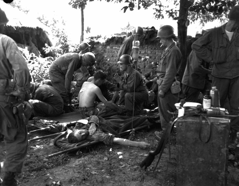  Wounded American soldiers are given medical treatment at a first aid station, somewhere in Korea in July 25, 1950