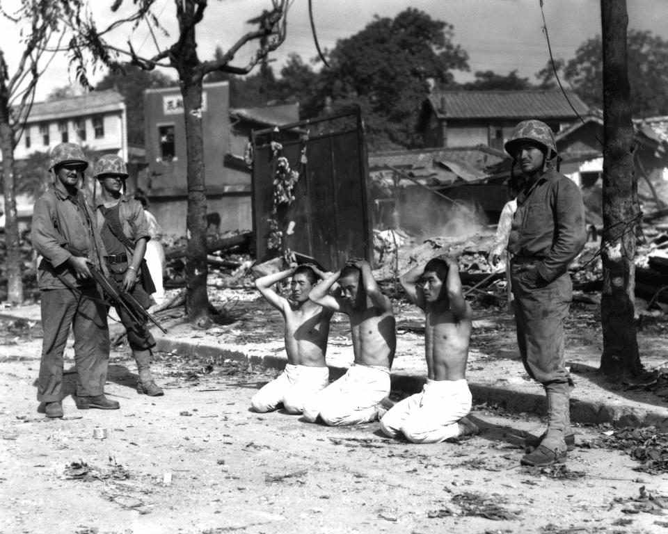  US Marines guarding three captured North Koreans after a fierce battle