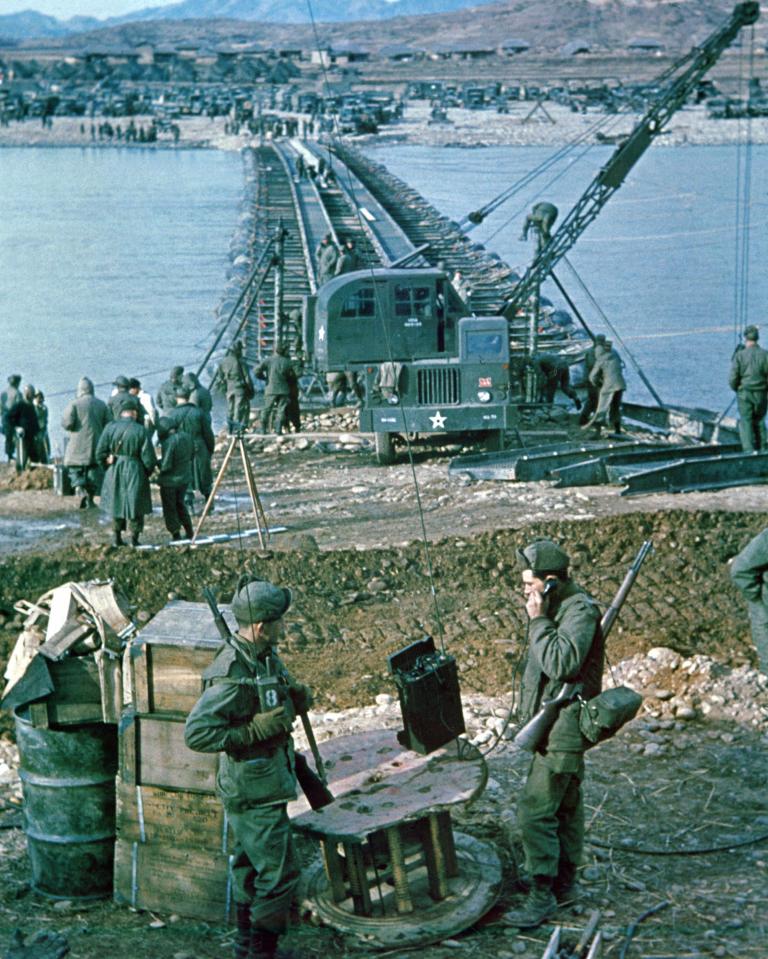  A company of the 9th Engineer Battalion, X Corps, construct a pontoon bridge over the Han River at the crossing point, seven miles south of Chunju, Korea