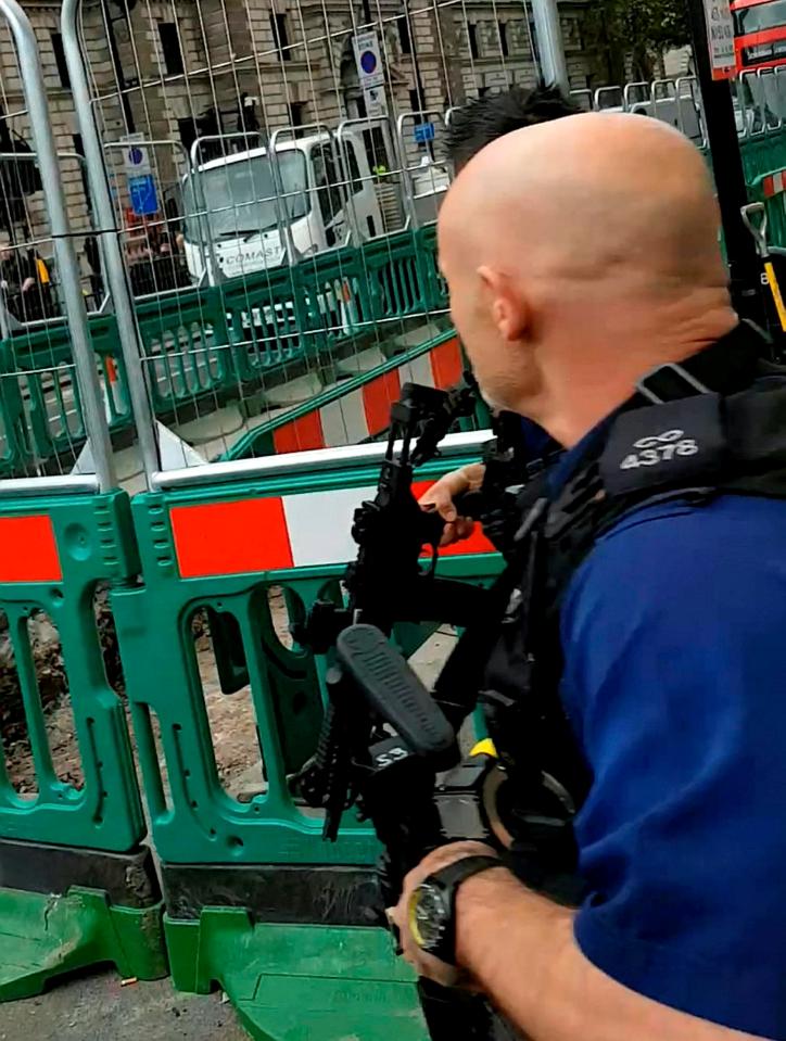  Heavily armed officers were seen running past shocked pedestrians